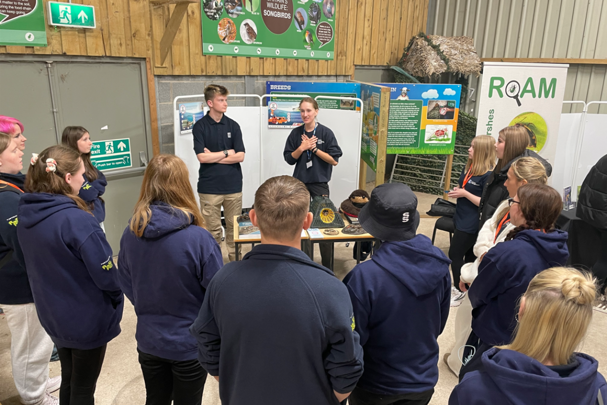 Students standing listening to the talks 