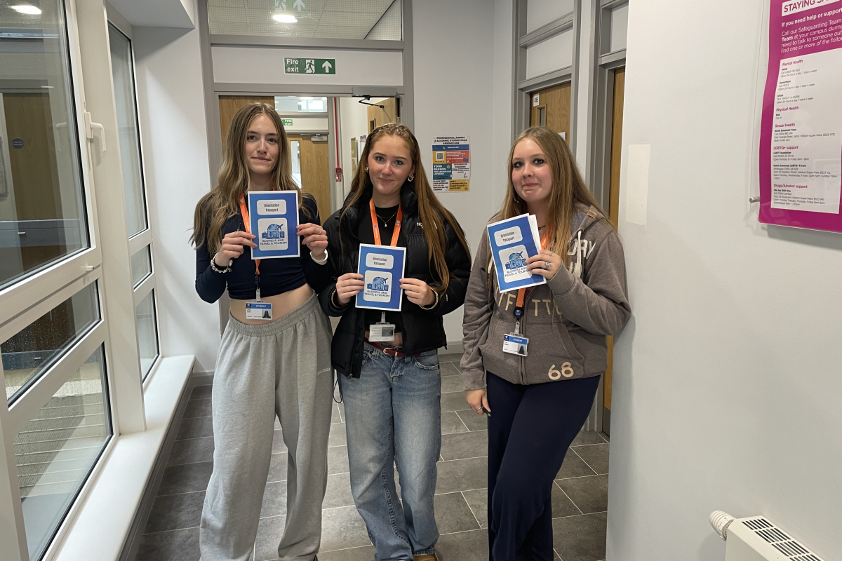 3 travel students holding passports they made