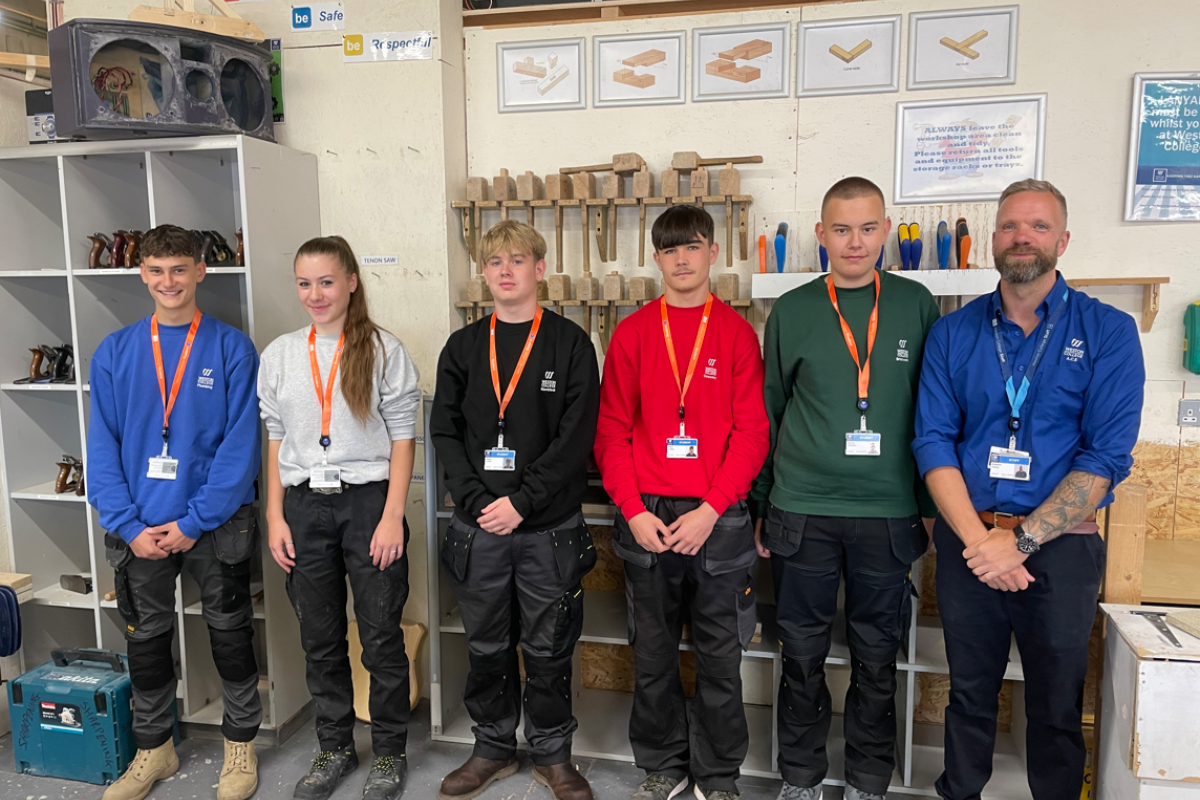 Construction students showing off their new uniforms