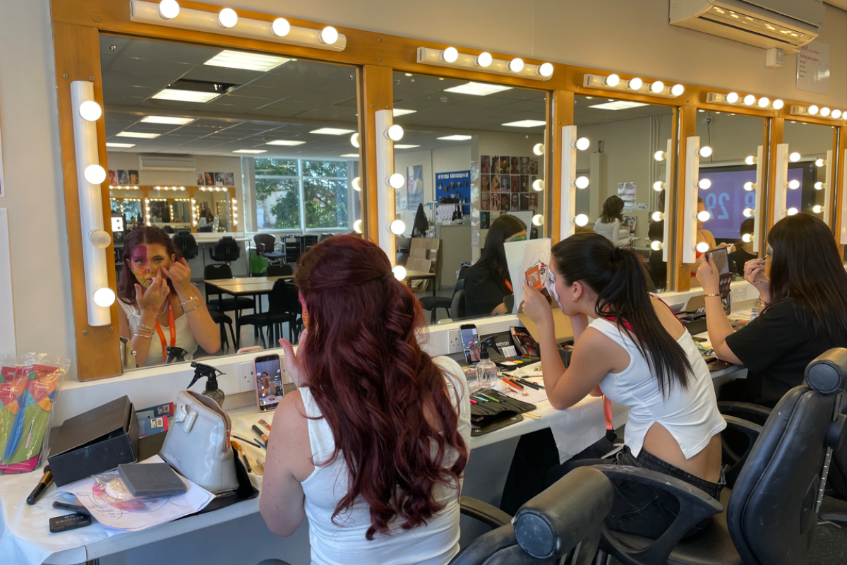 Media makeup students practicing creative face paint 