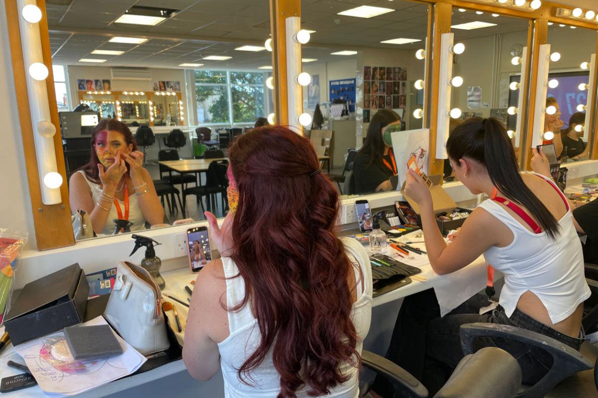 Media makeup students practicing creative face paint 