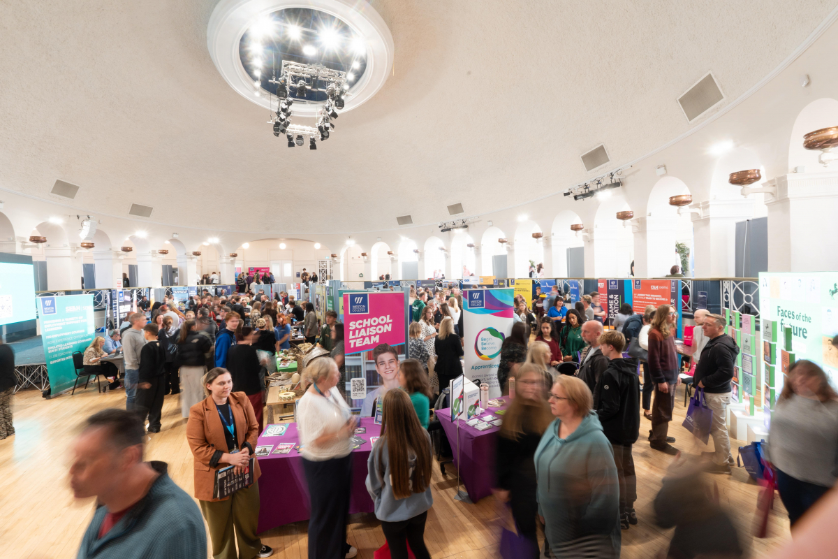 View of ballroom and attendees walking around looking at stands