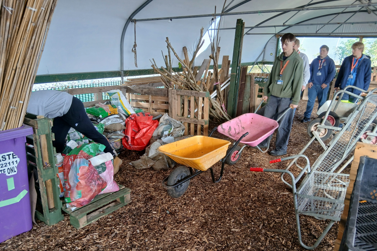 Student pushing a wheelbarrow