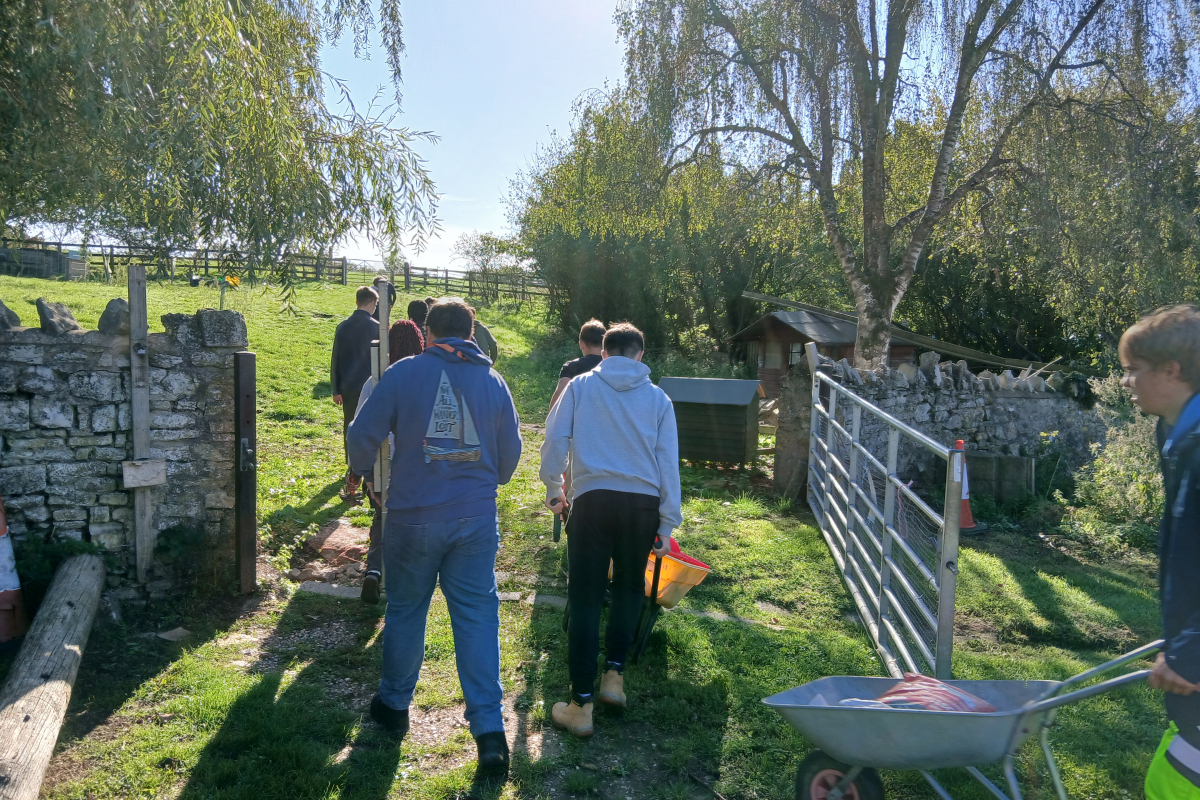 Students pushing wheelbarrows