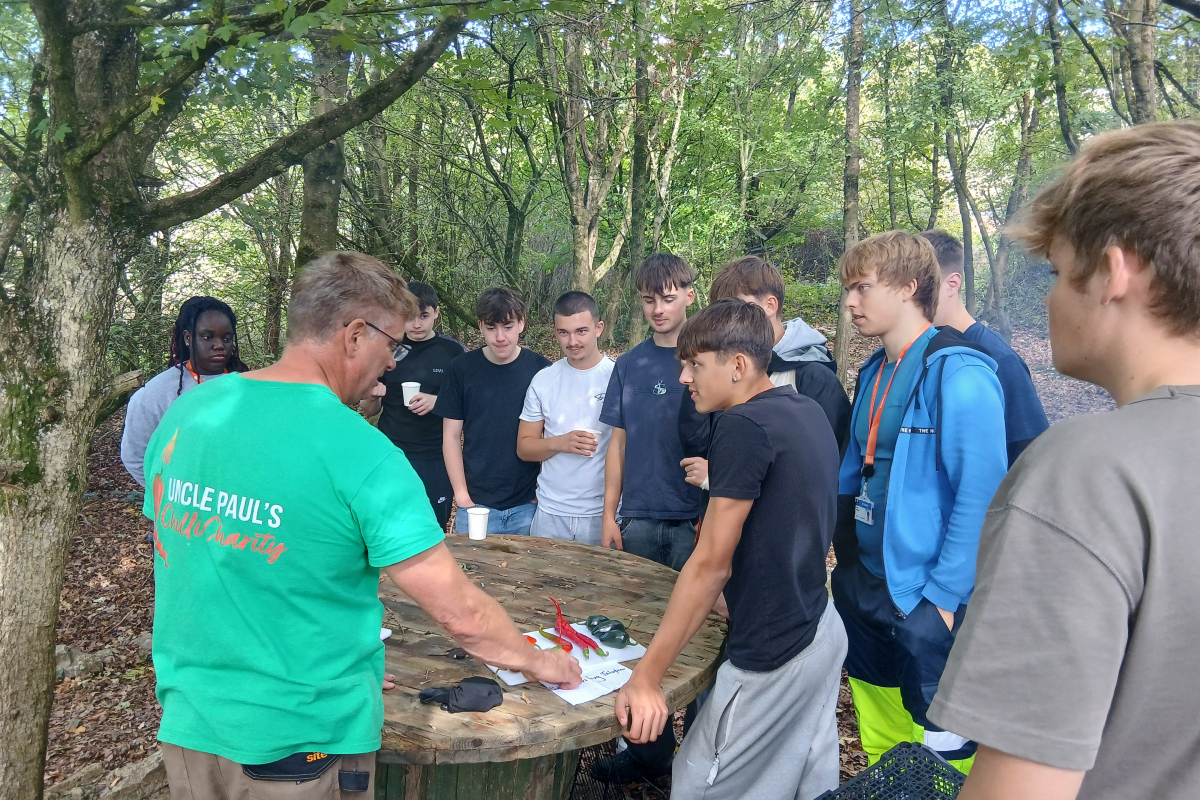 Students hearing about chilli's from a professional at the farm