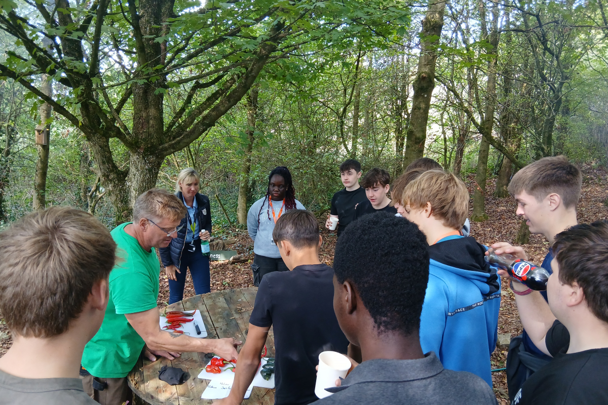 Students hearing about chilli's from a professional at the farm 