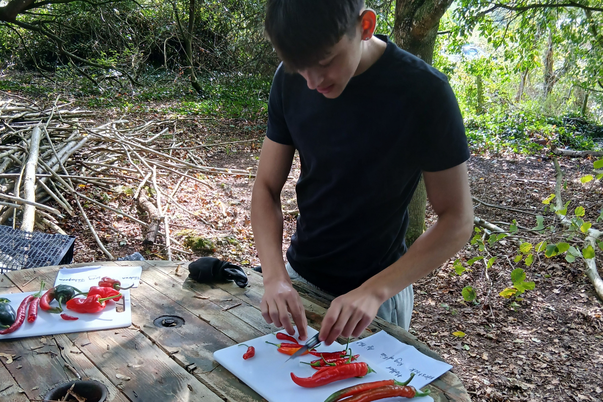 Student cutting up a chilli 