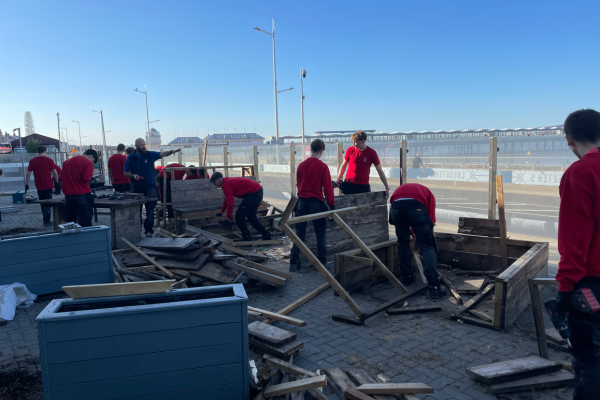 Students disassembling wooden benches 