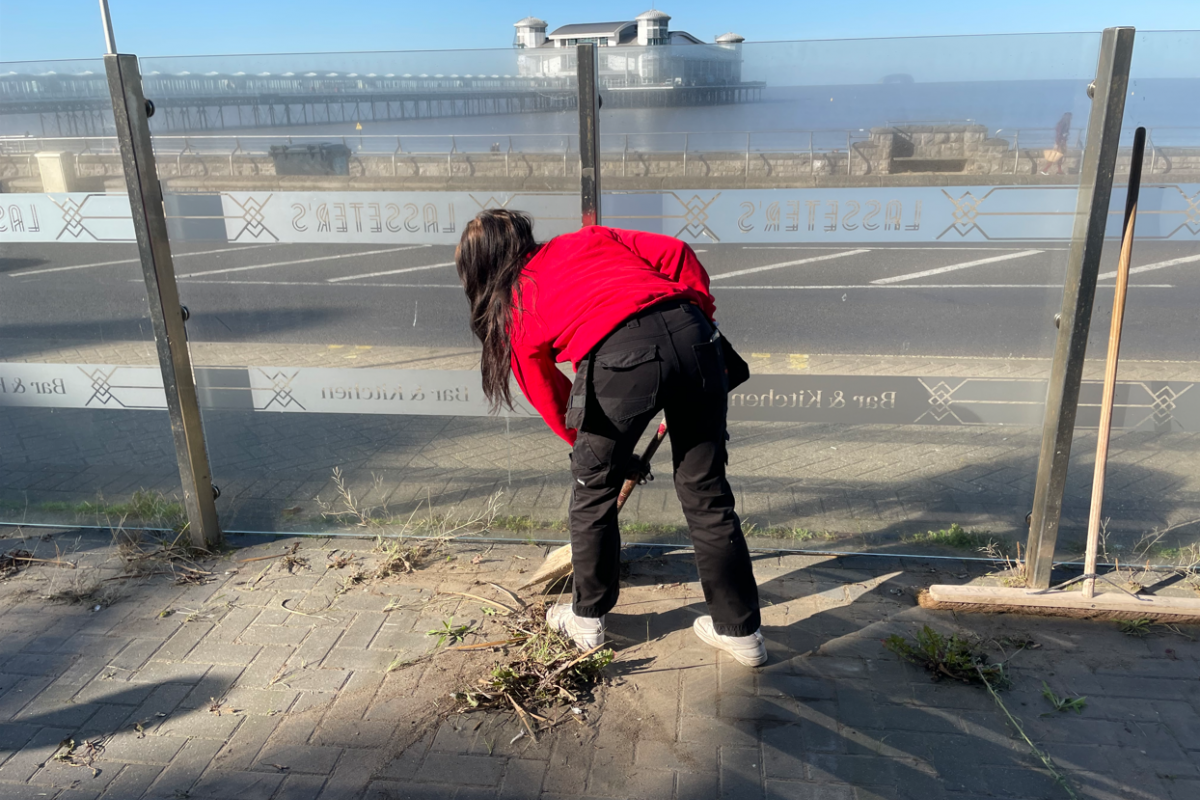 Student sweeping the floor