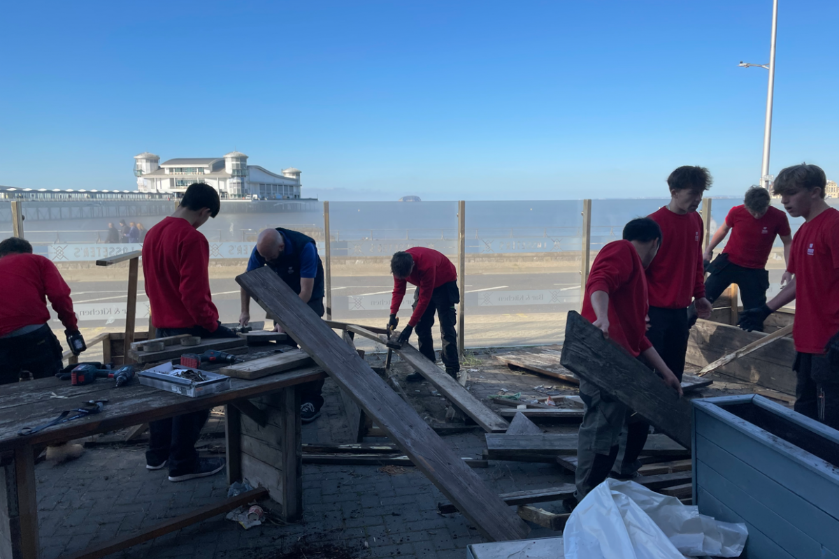 Students disassembling wooden benches