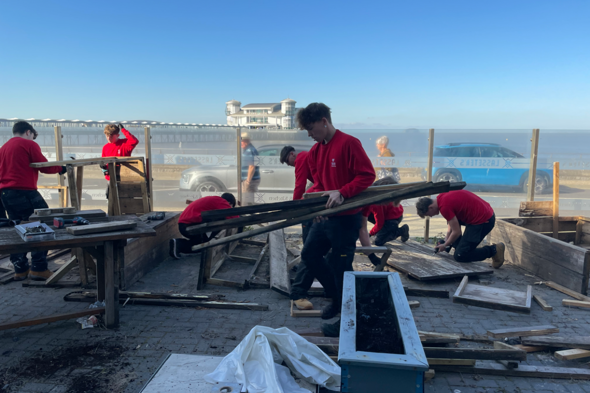 Students disassembling wooden benches