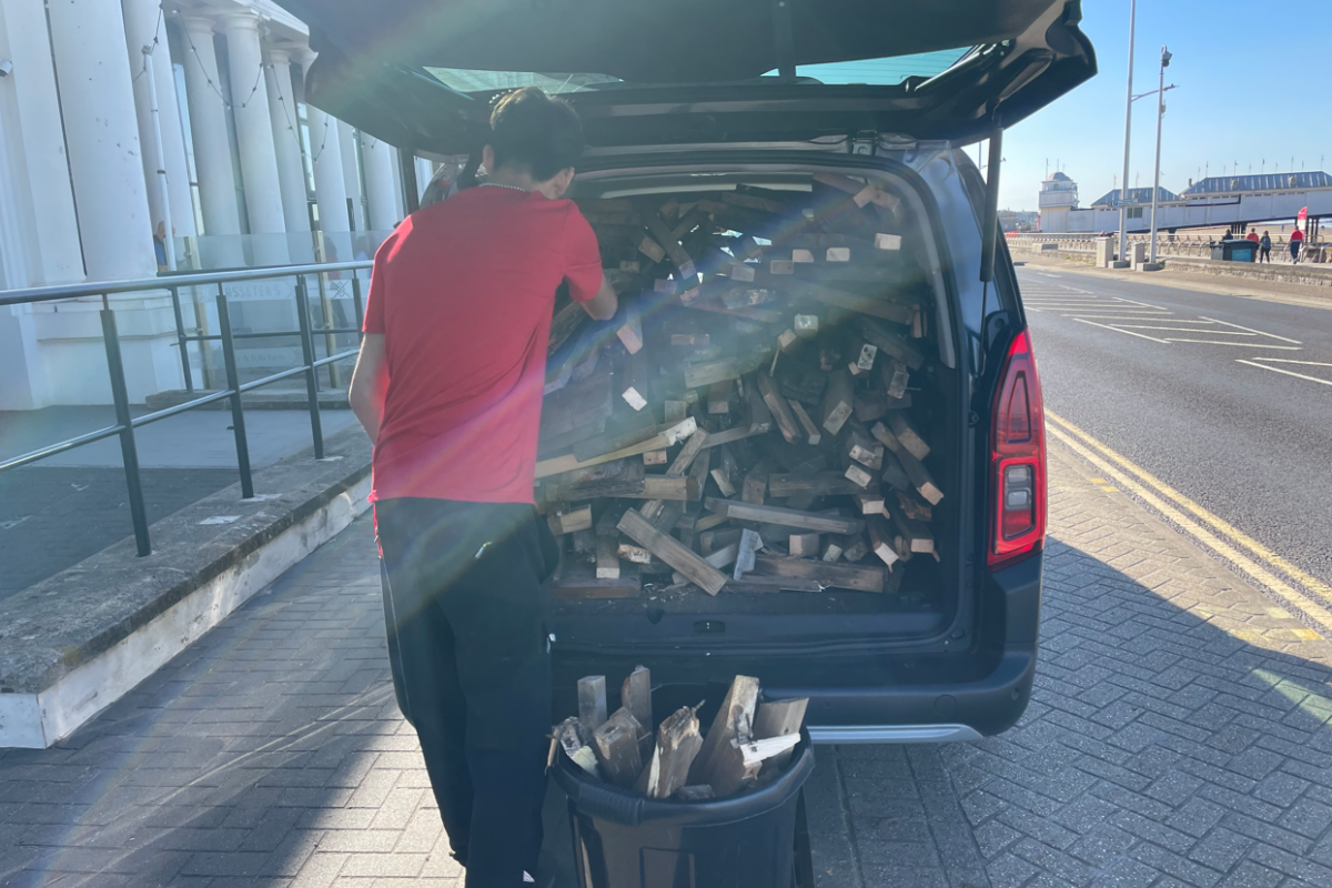 Wood piled in the back of a van 