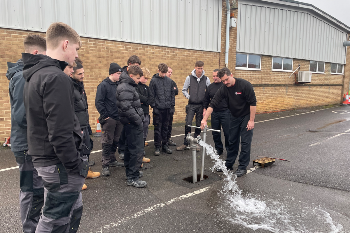 firefighter tapping into fire hydrant water