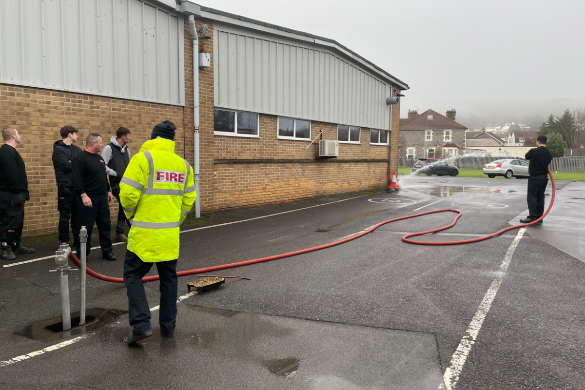 firefighter spraying water through the hose