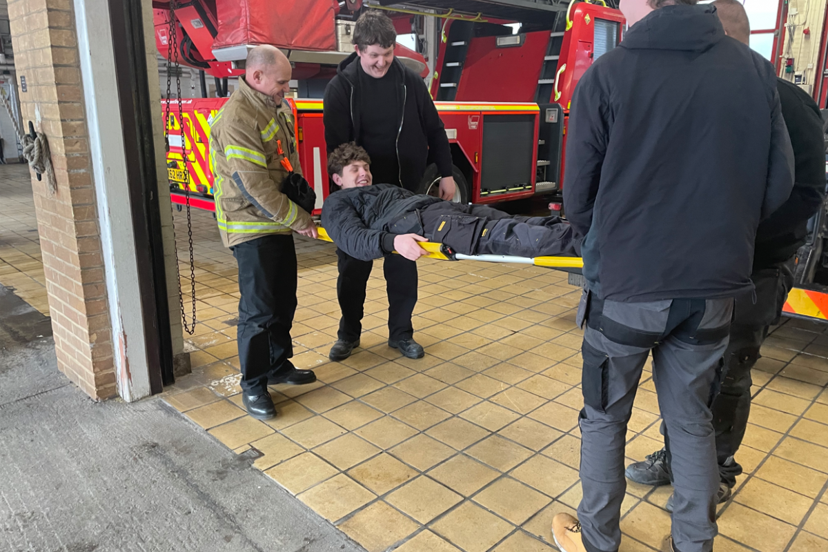 students being picked up on a stretcher 