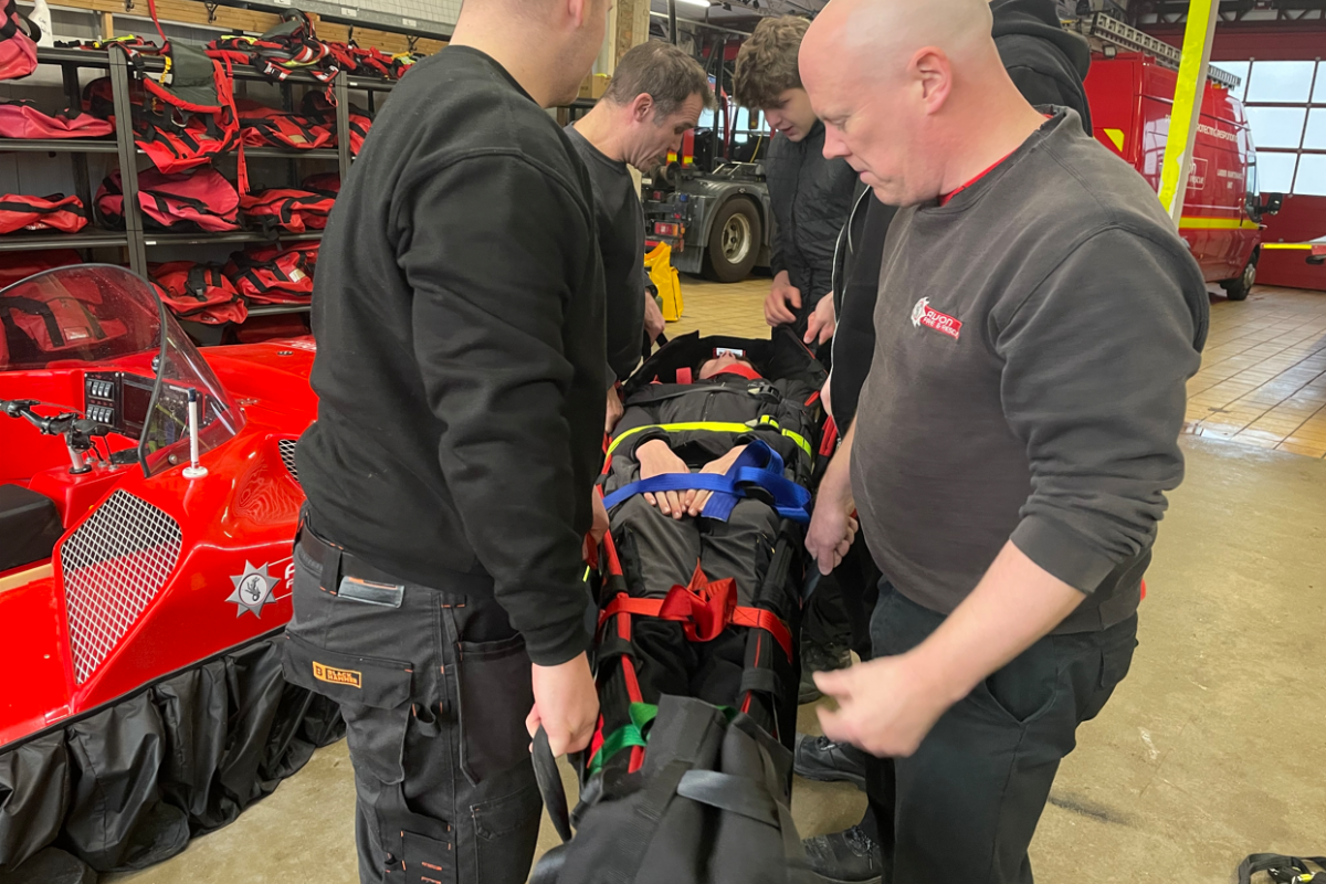 students being picked up on a stretcher 