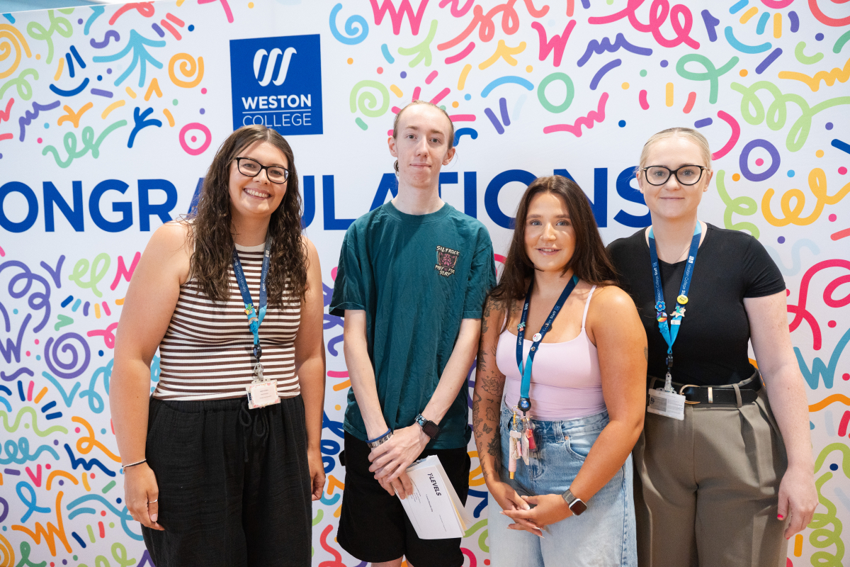 Student with lecturers in front of backdrop
