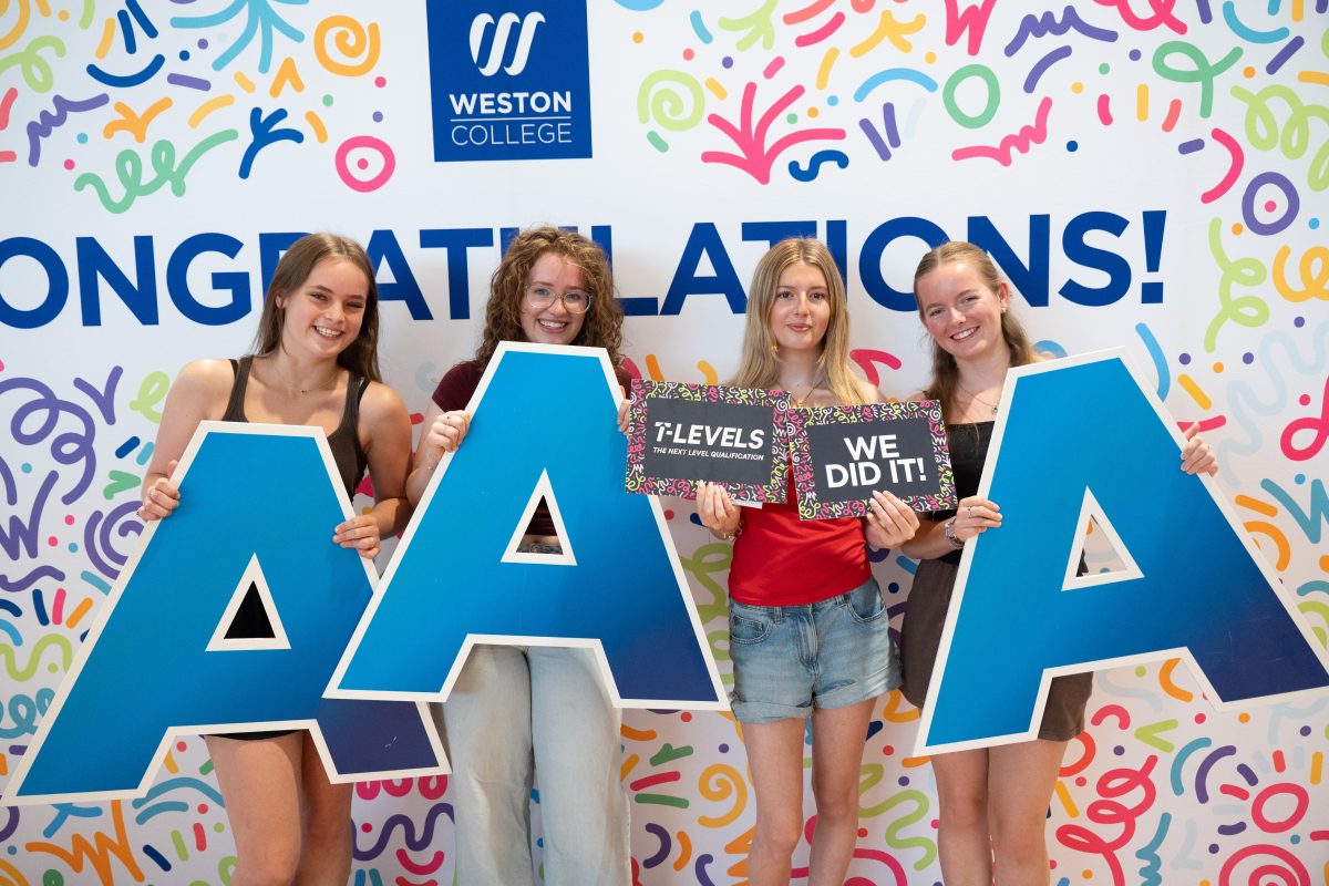 Students posing with photobooth props 