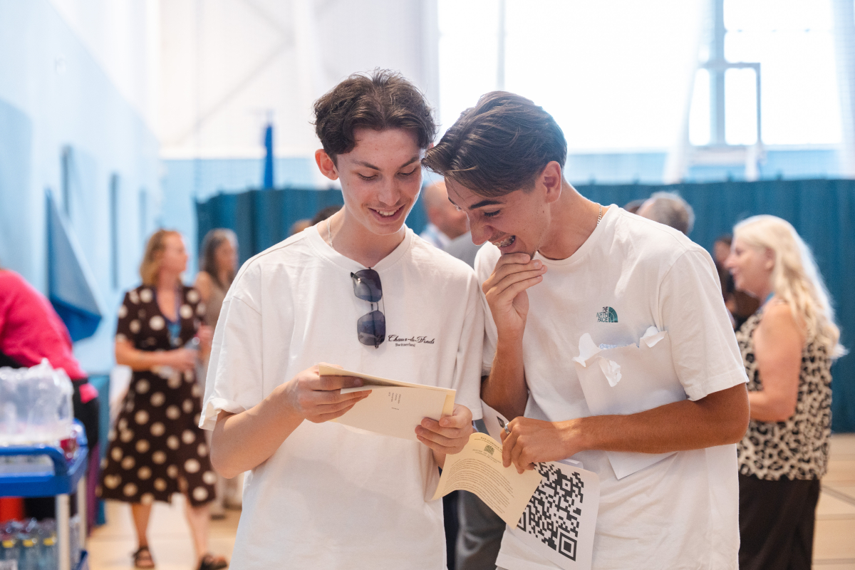 2 learners looking at their results together 