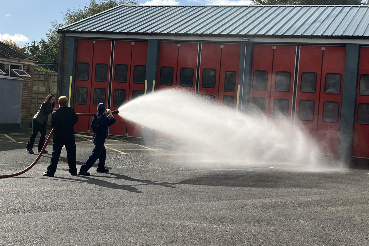 Students holding water hose