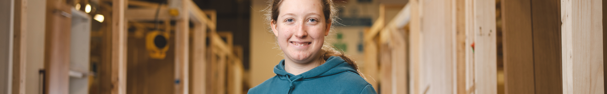 Sophie holding drill in carpentry facilities at weston college