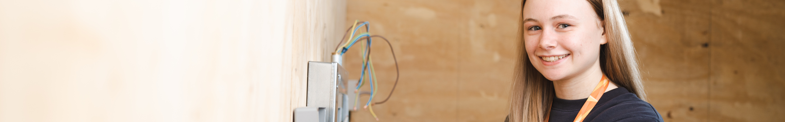 student standing in practical exercise smiling