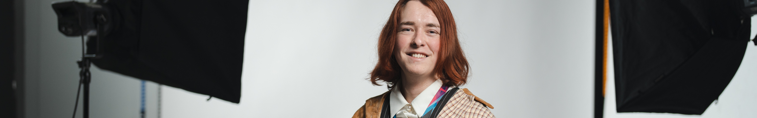 Student studying photography in weston-super-mare holding camera in photography studio