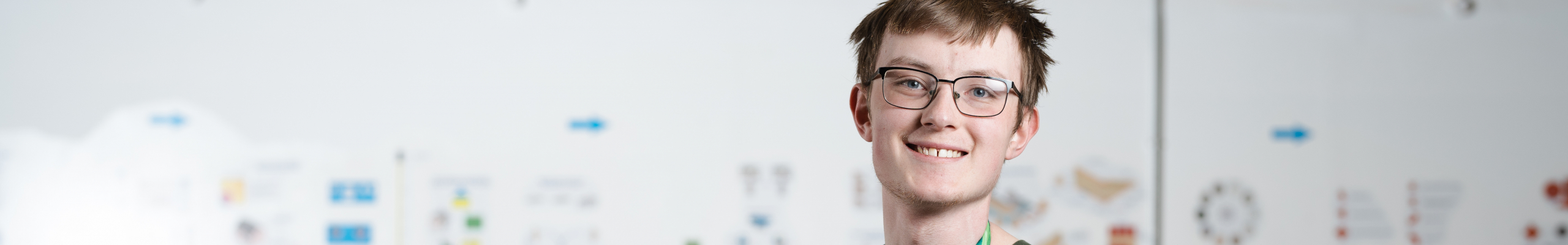 Male student in front of bricks