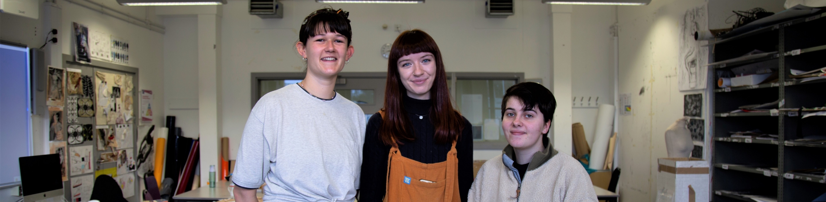 3 students smiling at camera