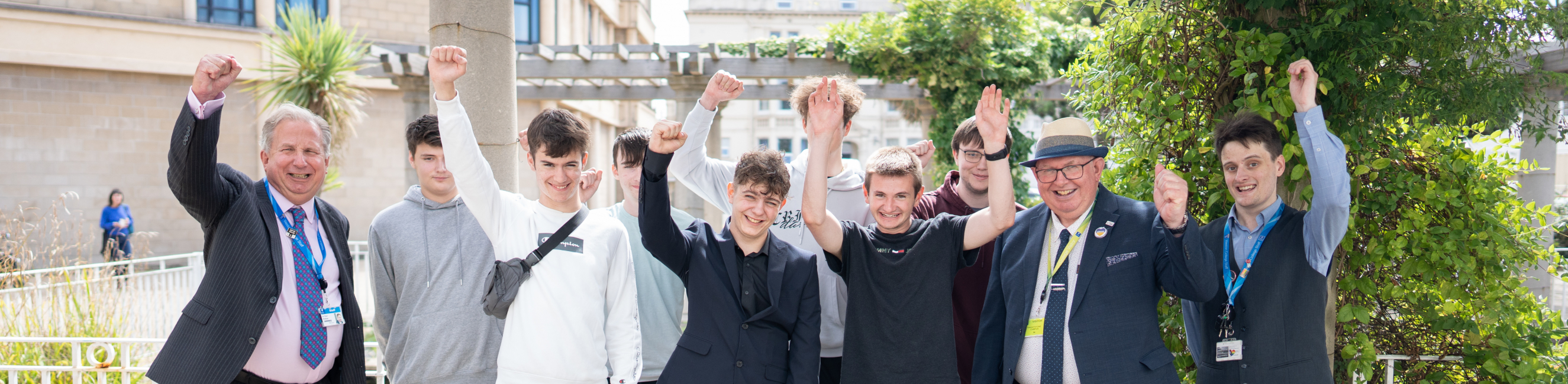 T Level learners cheering with Dr Paul Phillips