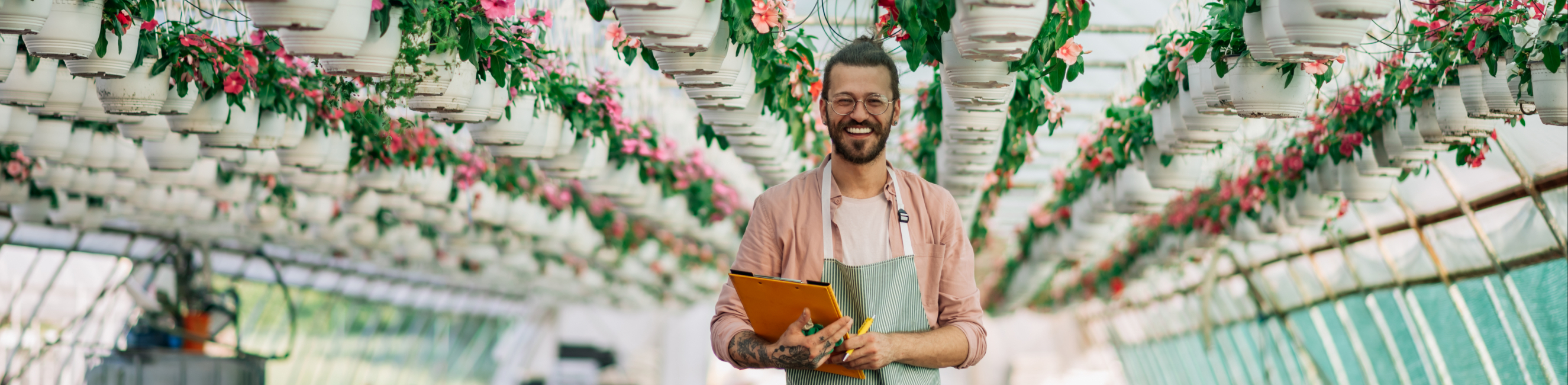 Smiling man holding clipboard