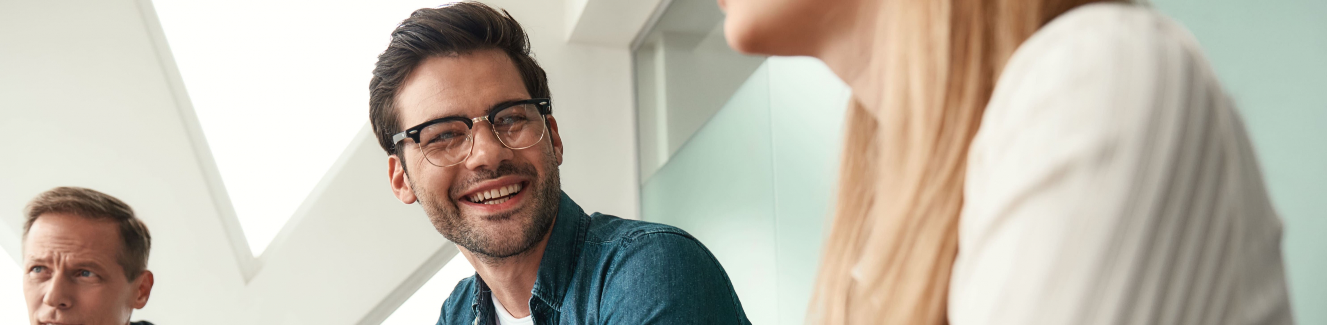man smiling in a meeting