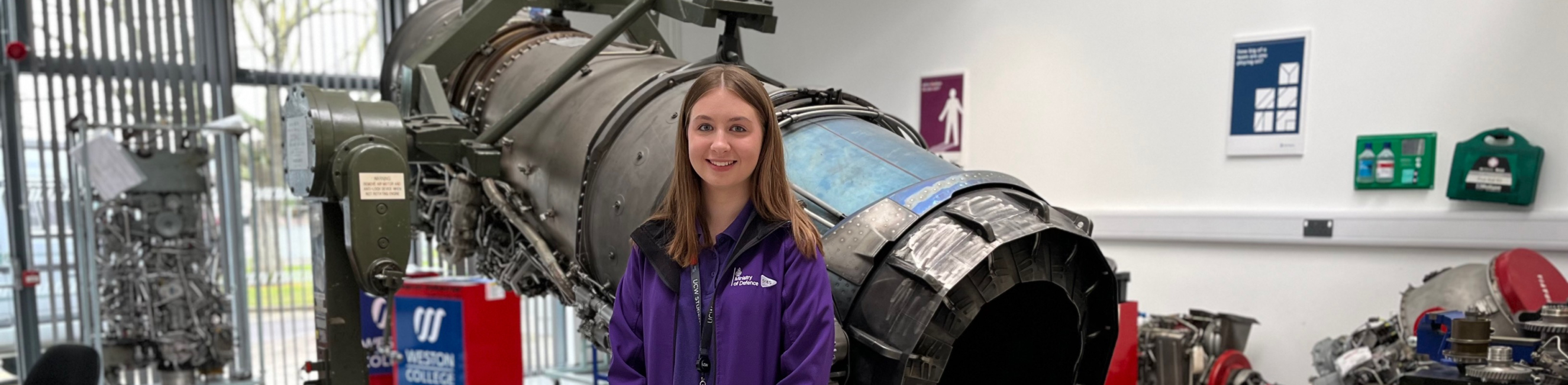 Georgia, MoD Apprentice, standing in front of jet
