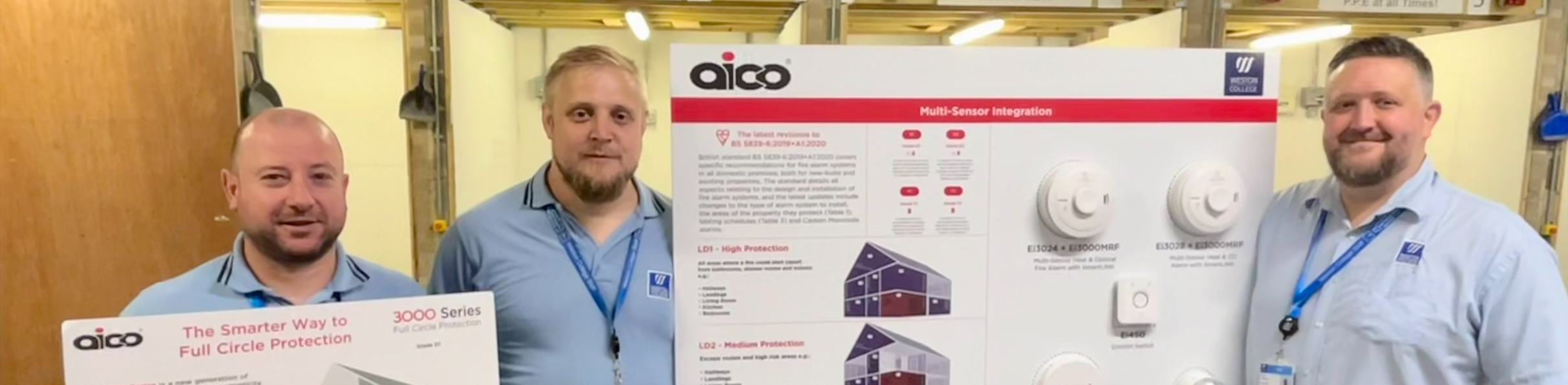 Alex, Lee and Andy holding Aico promotional board