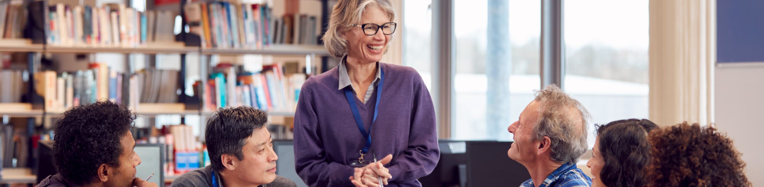 teacher with adult learners in classroom