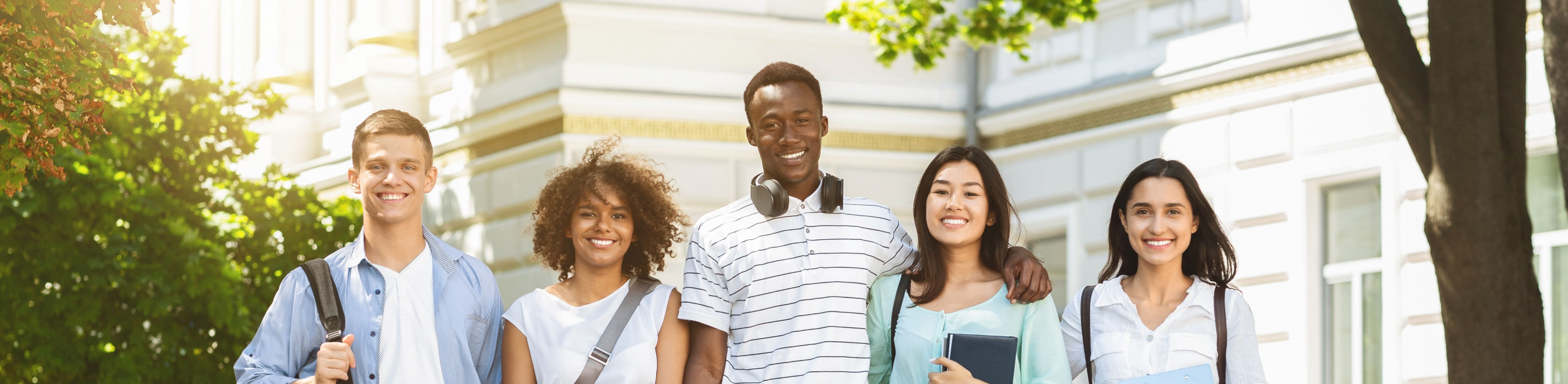 students smiling in a row of 5