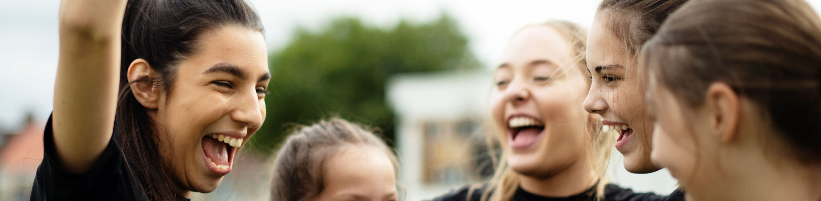 Cheerful female football players celebrating