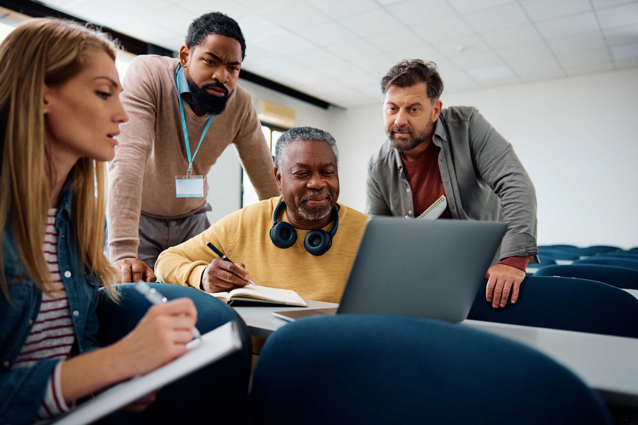 Adult learners working on a laptop
