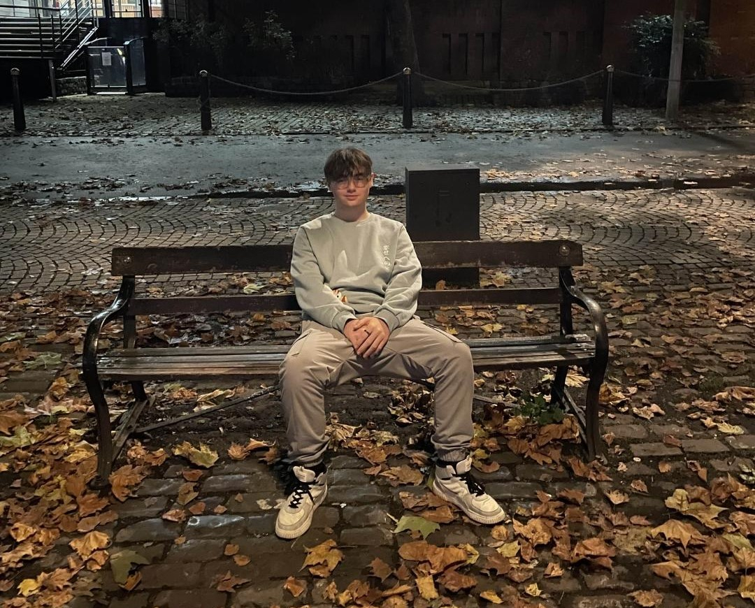 Callum sitting on a bench