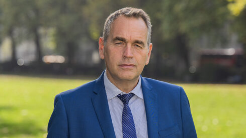 Lee Elliot Major standing in a field looking serious