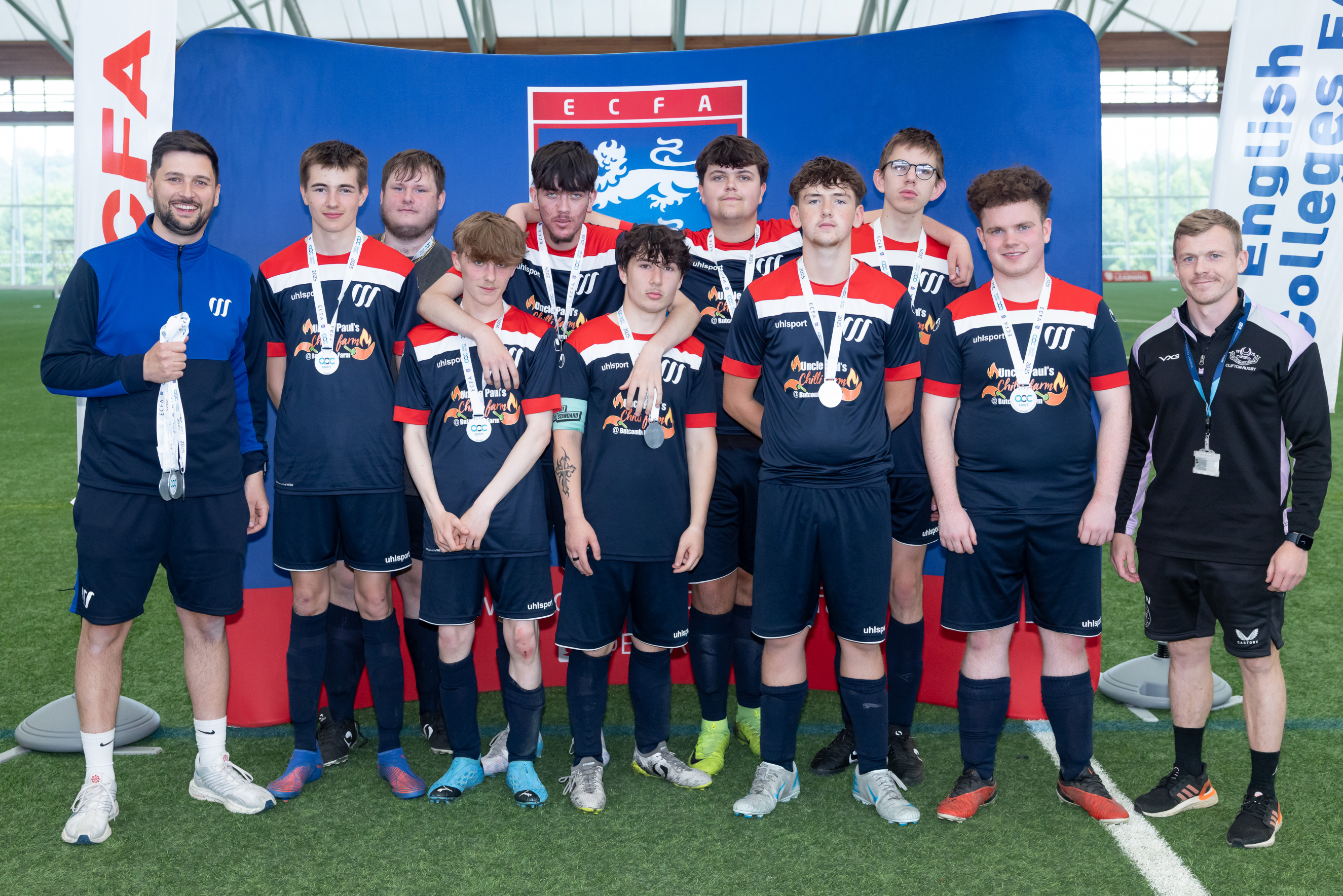 weston college's football academy team standing in front of backdrop
