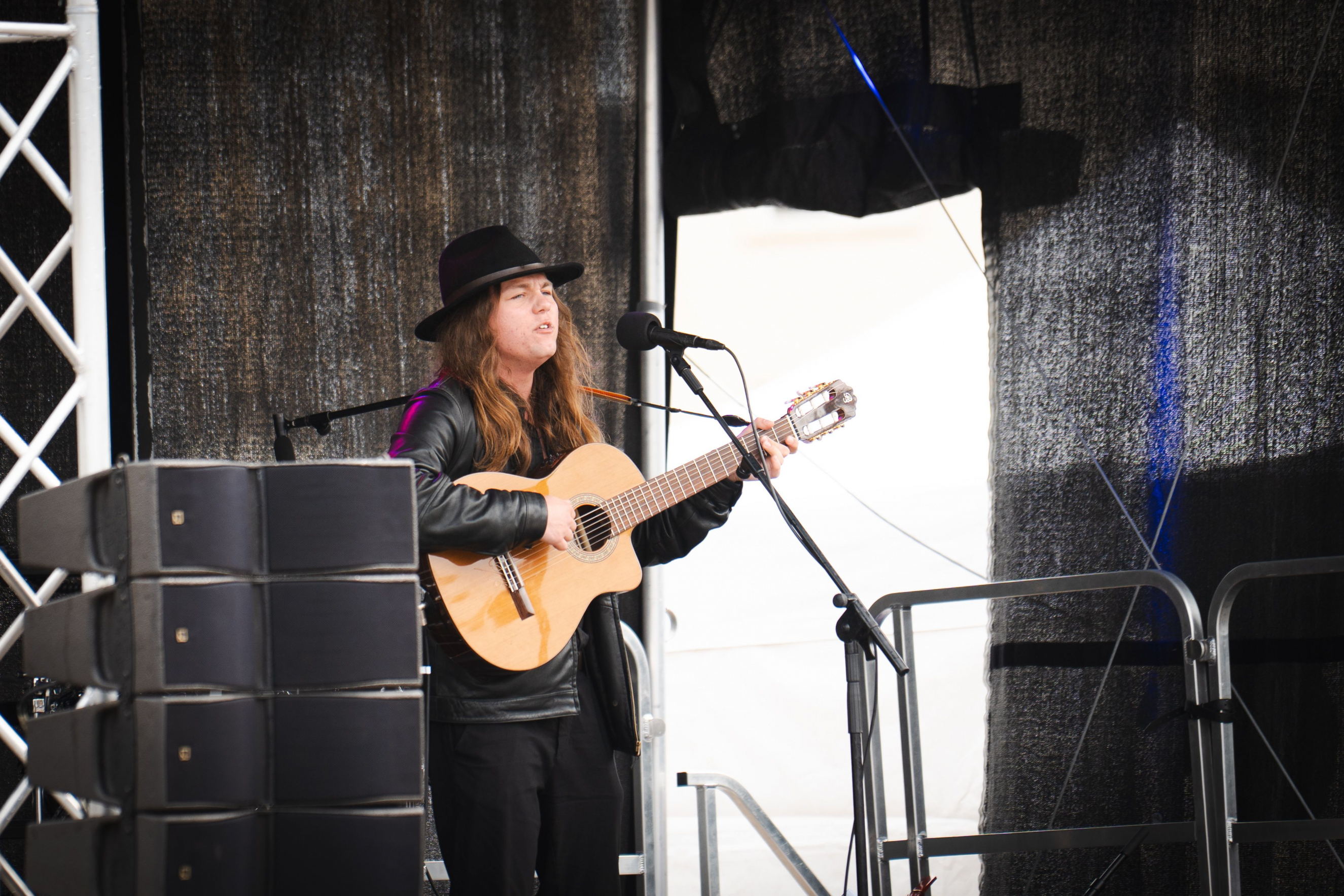 Student playing the guitar on stage
