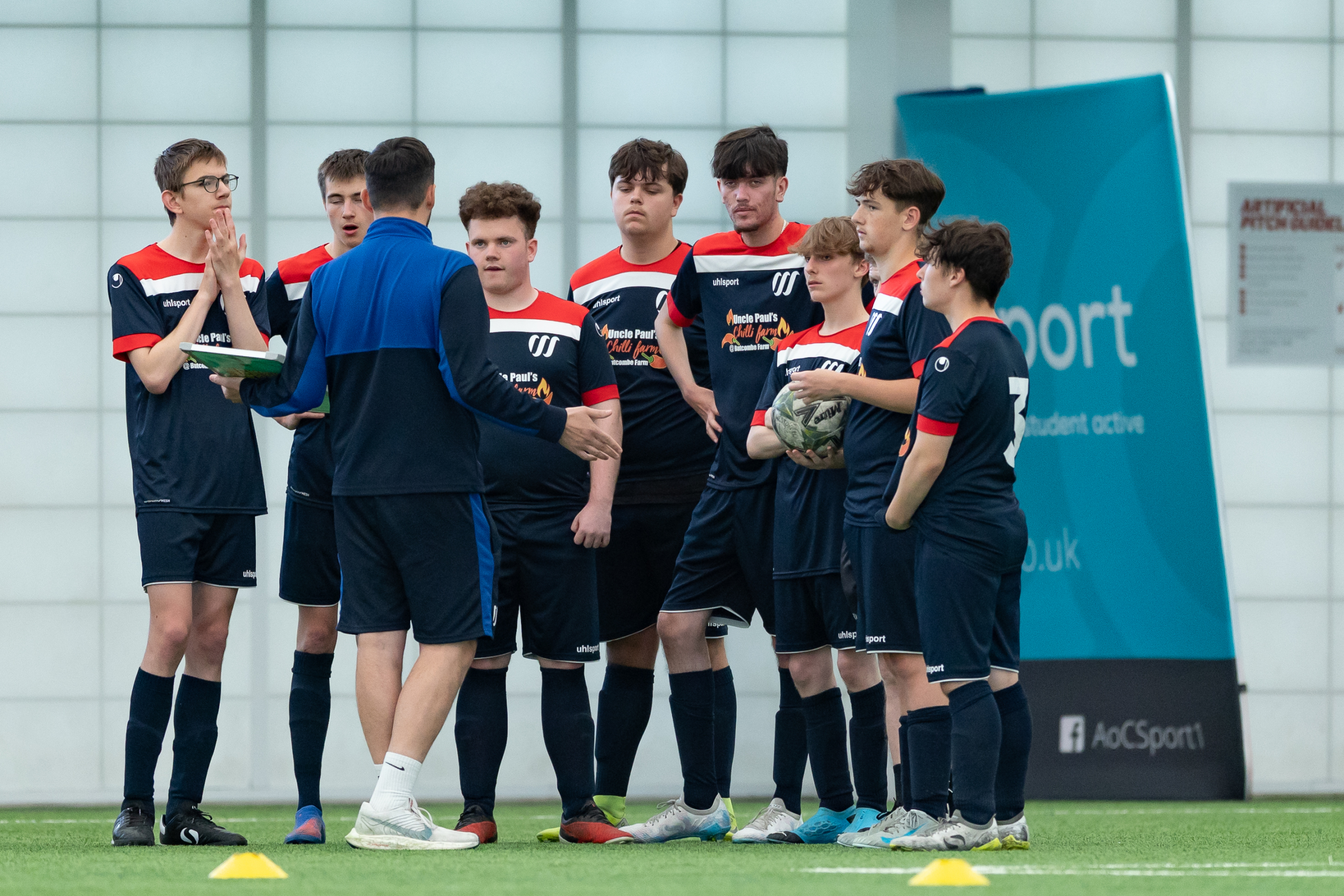 weston college's football academy team having a pep-talk on the pitch