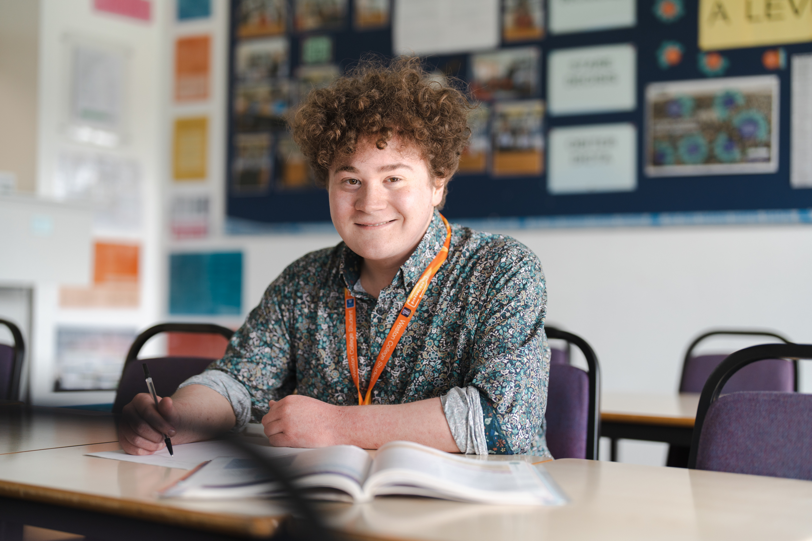 A Level student writing in a workbook