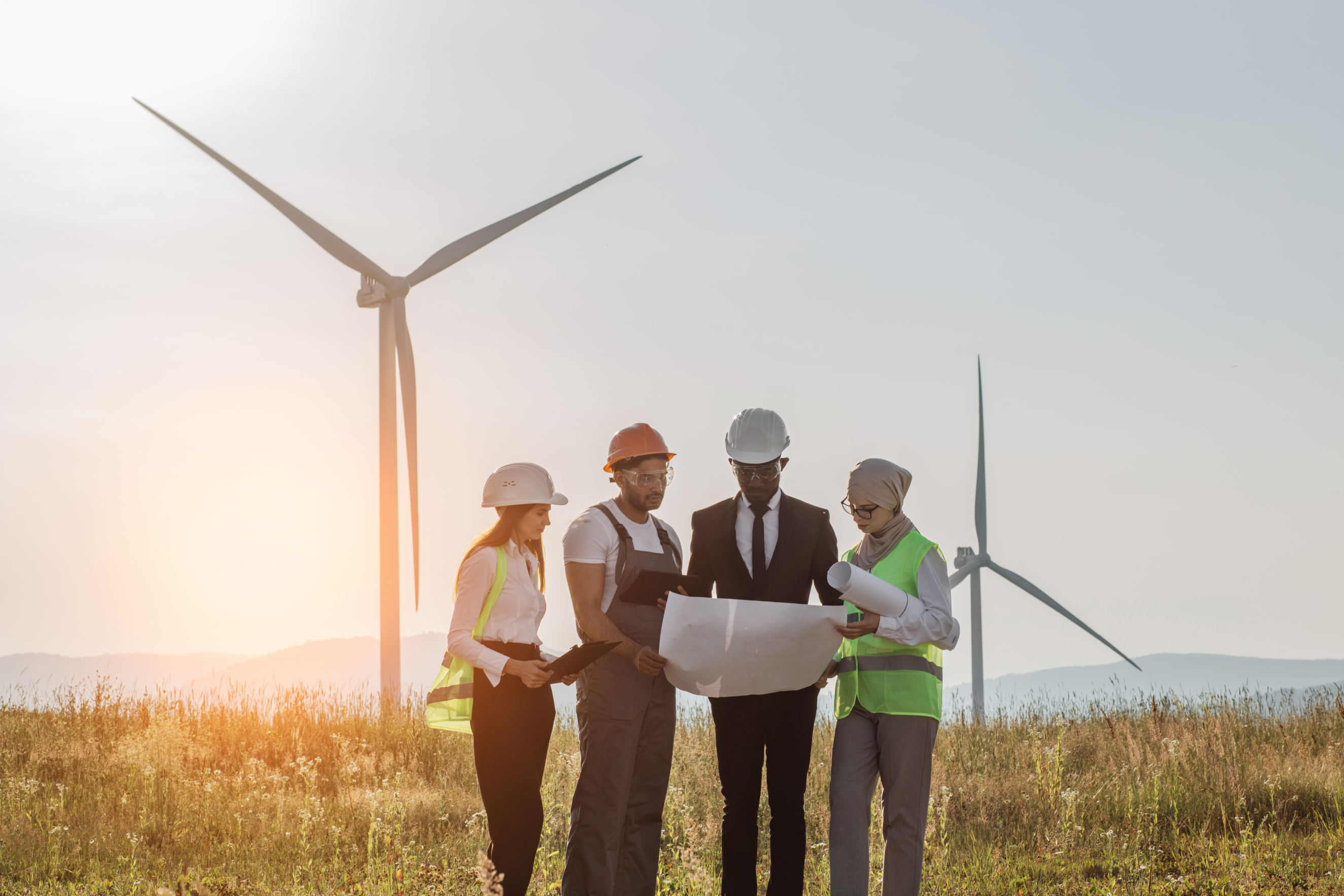 Staff Stood infront of windmills