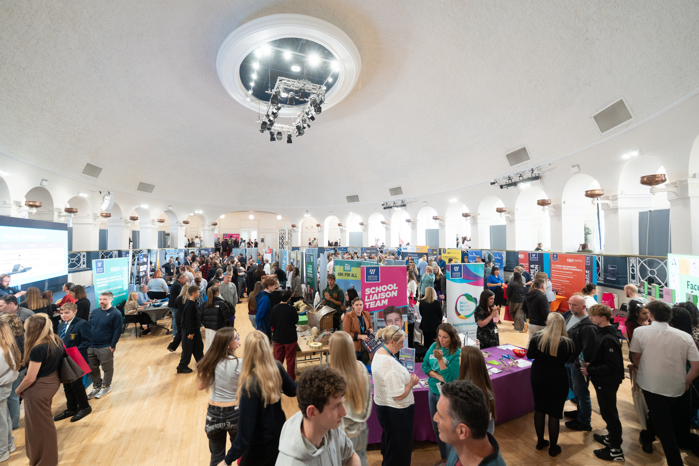 Attendees in Ballroom looking at employer stands