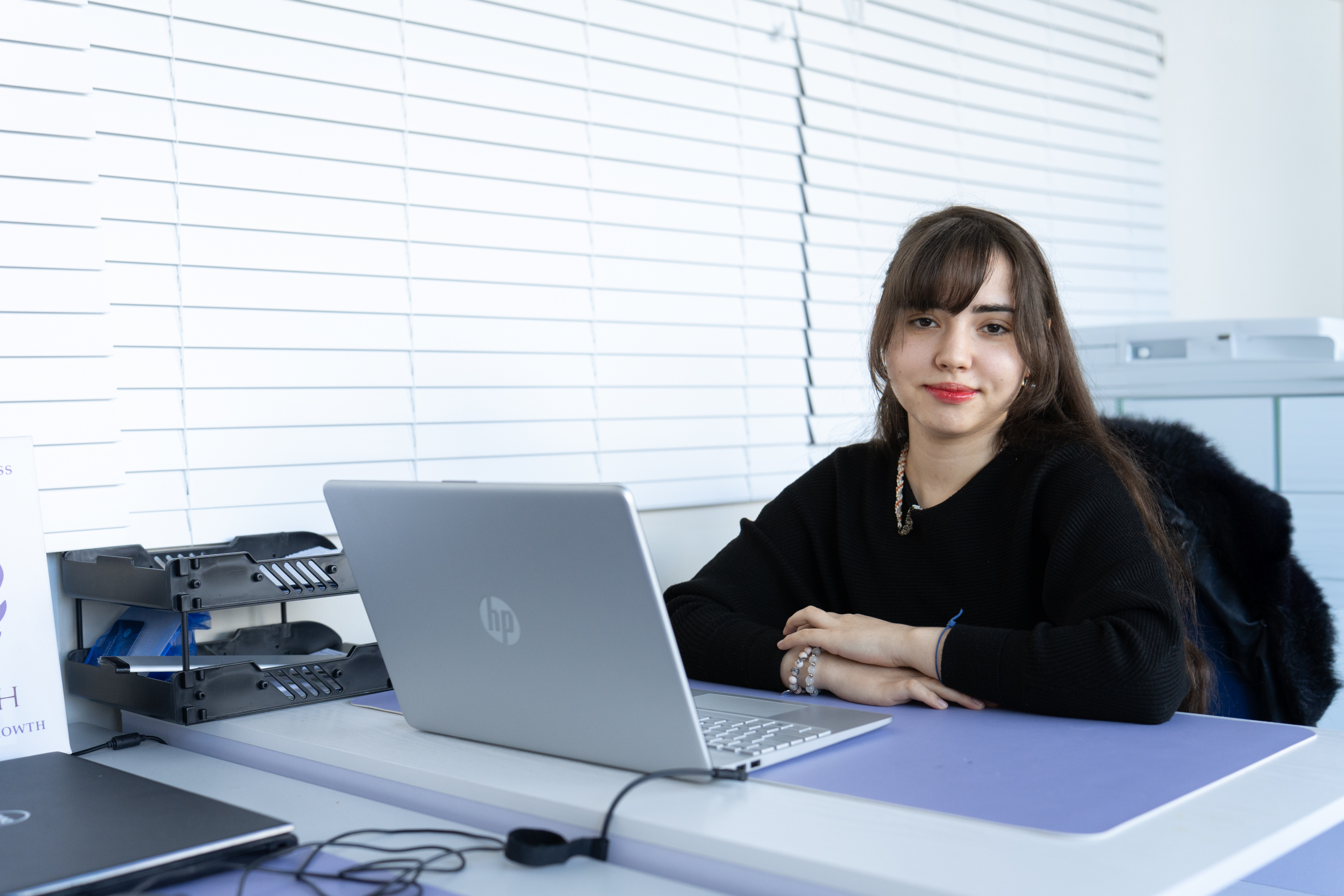 T Level Learner Greta sat behind laptop