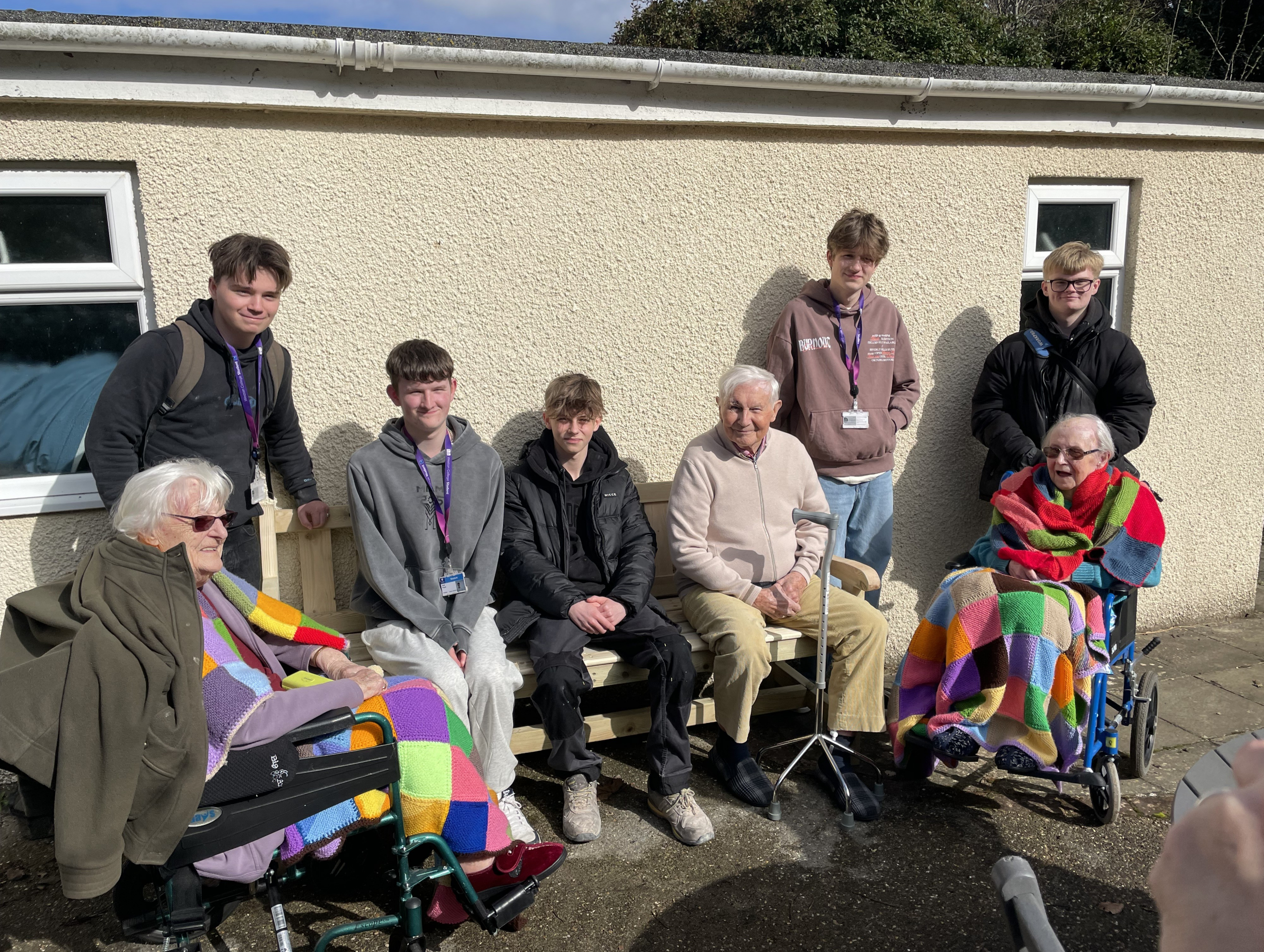 Students sitting with members of care home