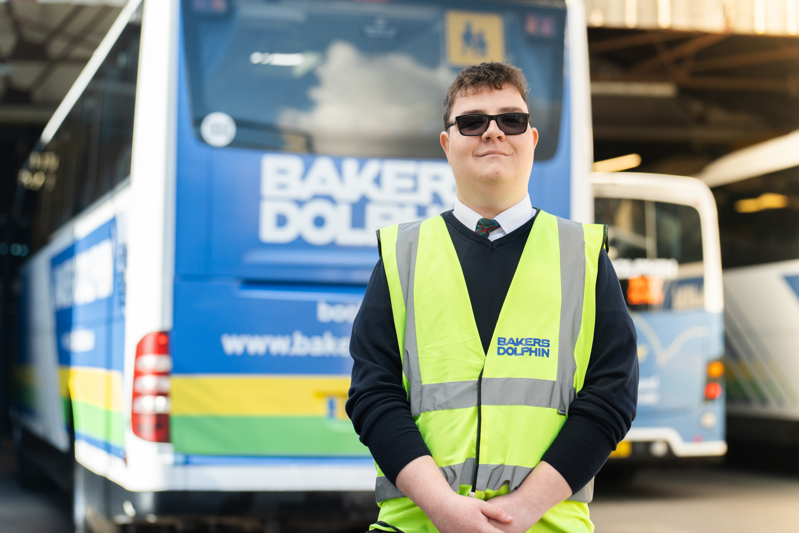 Harry Beasant smiling by Bakers Dolphin bus