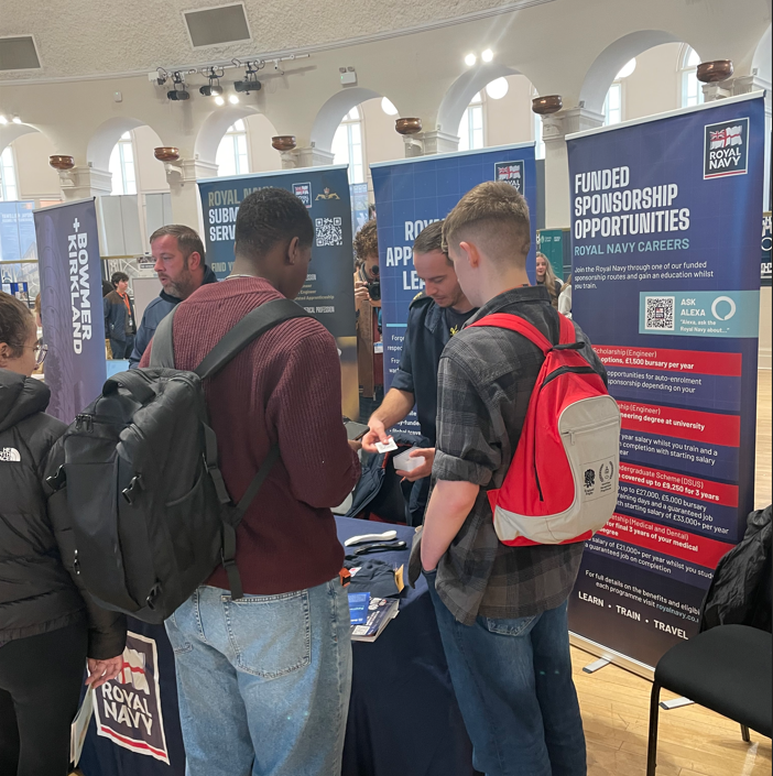 Two learners talking to the Royal Navy at CareersFest